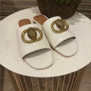 Women's Kurt Geiger White Patent Slide Sandals with Gold Medallion
